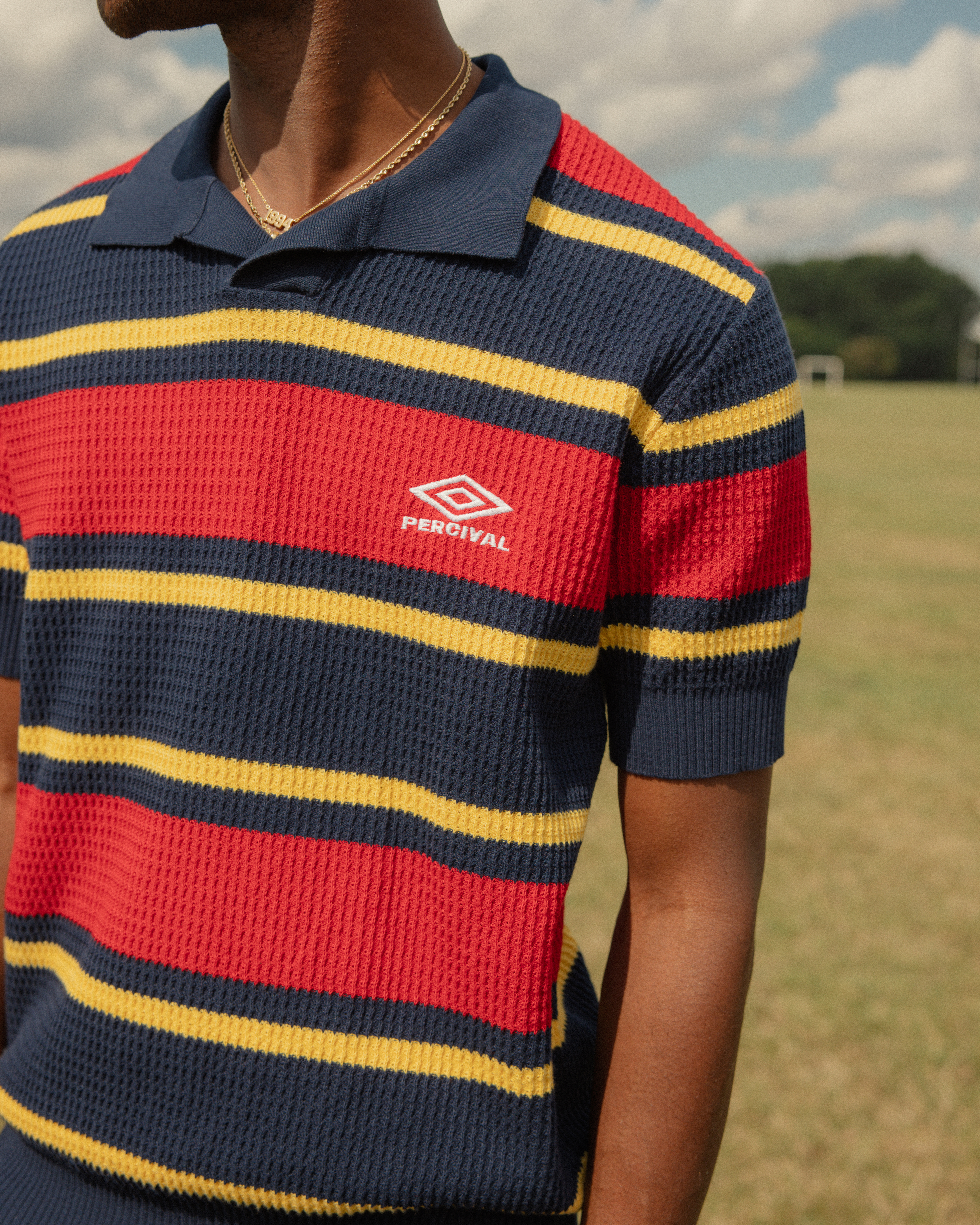 percival-x-umbro-male-model-wearing-red-and-navy-training-polo