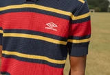 percival-x-umbro-male-model-wearing-red-and-navy-training-polo