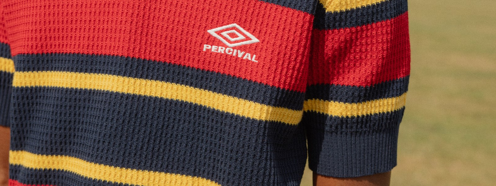 percival-x-umbro-male-model-wearing-red-and-navy-training-polo