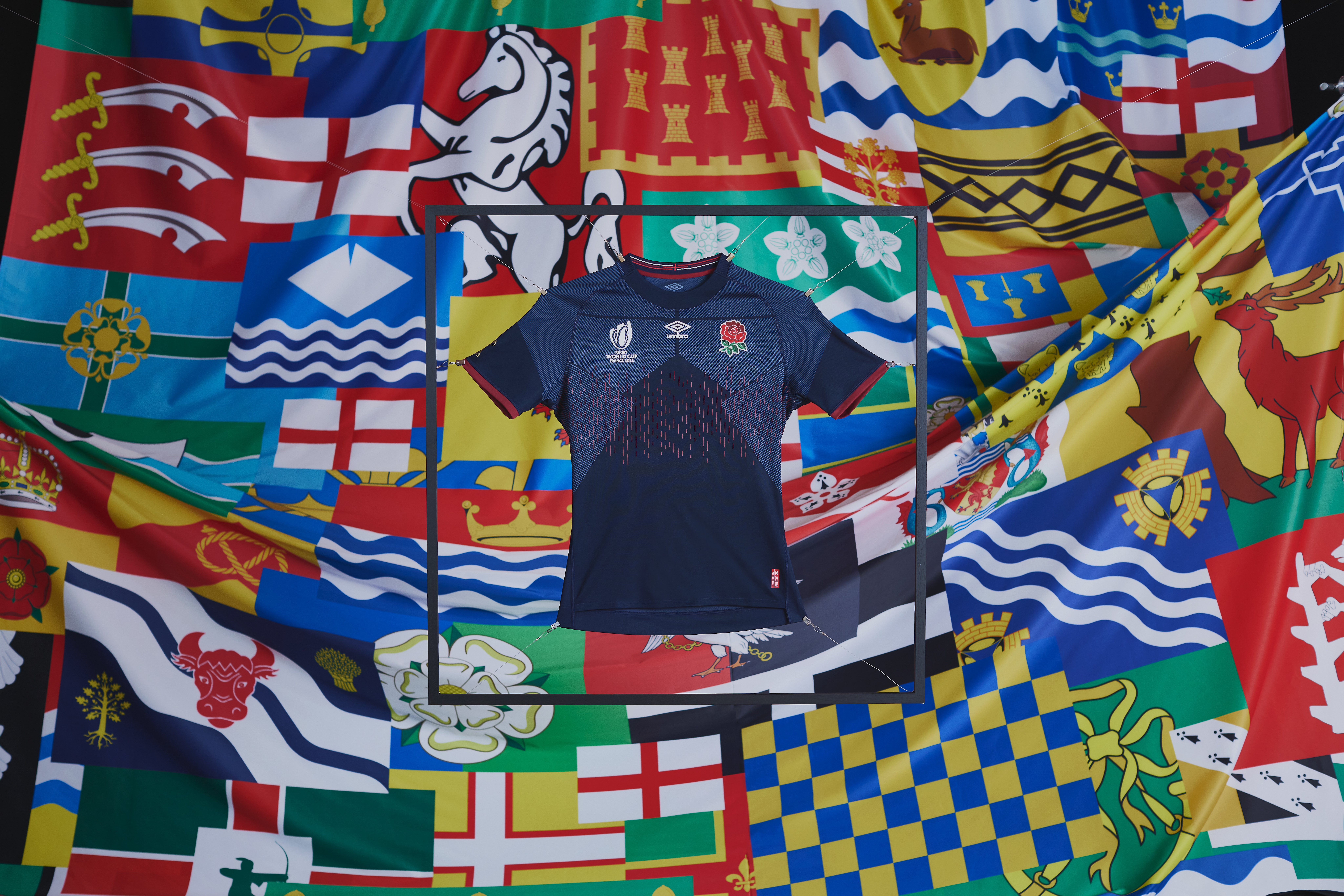 umbro-england-rugby-23-24-alternate-jersey-held-up